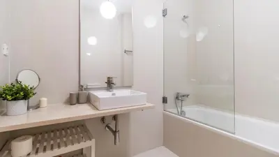 a white bathroom with a sink and a shower at Bento Living by LovelyStay in Porto