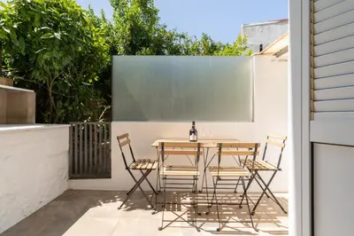 a table and chairs on the patio of a house at Host Wise - Classy Amazing Flats in Porto
