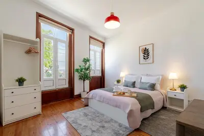 a white bedroom with a bed and a window at Host Wise - Classy Amazing Flats in Porto