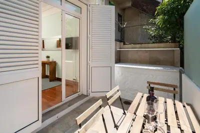 a patio with a table and two chairs and a tub at Host Wise - Classy Amazing Flats in Porto