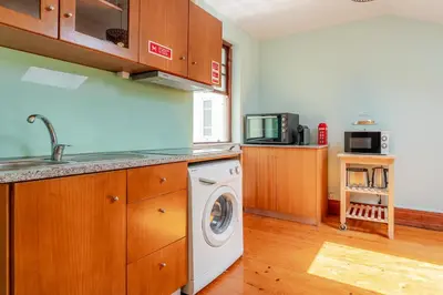 a kitchen with a washing machine and a sink at Host Wise - Classy Amazing Flats in Porto