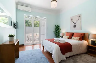 a bedroom with a large bed with a red and white blanket at Host Wise - Classy Amazing Flats in Porto