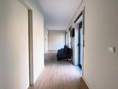 a hallway with a couch in the middle of a room at Casas S. Dinis in Porto