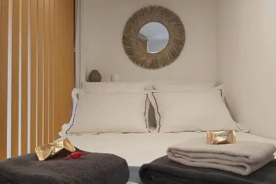 a bedroom with a white bed with a mirror at Loft in the historic center of Oporto downtown in Porto