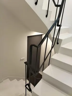 a black chair sitting next to a staircase at Loft in the historic center of Oporto downtown in Porto