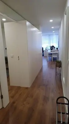 a room with a hallway with a white door and a table at A H - Apartment Oporto Downtown in Porto