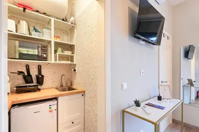 a small kitchen with a sink and a refrigerator at Julio Dinis Porto Secret Retreat - by Guest SPA in Porto