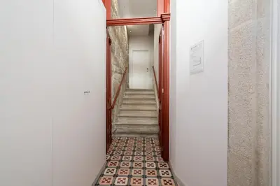 a hallway with a stairway leading up to a room at Host Wise - Refreshing Cozy Flat - Garden & Terrace in Porto