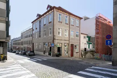 a large brick building on a city street at Host Wise - Refreshing Cozy Flat - Garden & Terrace in Porto