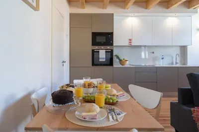 a table with food and drinks on it in a kitchen at Host Wise - Lovely & Cozy Duplex Flat in Porto