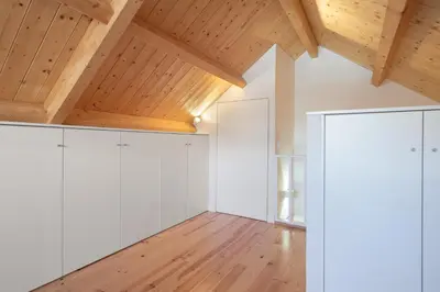 a room with white cabinets and wooden ceilings at Host Wise - Lovely & Cozy Duplex Flat in Porto