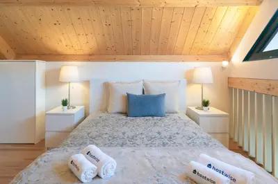 a bedroom with a bed with two pillows on it at Host Wise - Lovely & Cozy Duplex Flat in Porto