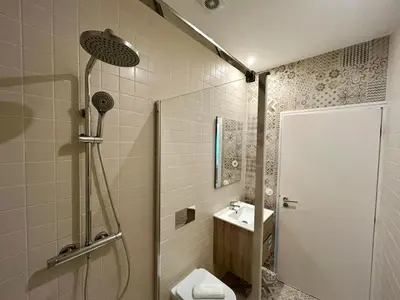 a bathroom with a shower and a toilet and a sink at Lemago Porto Apartments - Bonjardim in Porto