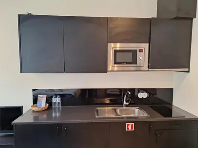 a kitchen with a sink and a microwave at Lemago Porto Apartments - Bonjardim in Porto