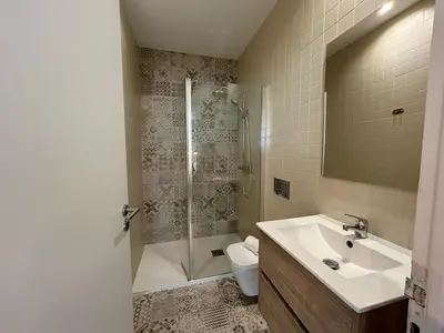a bathroom with a sink and a shower and a toilet at Lemago Porto Apartments - Bonjardim in Porto