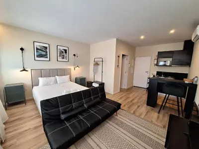 a bedroom with a bed and a couch and a desk at Lemago Porto Apartments - Bonjardim in Porto