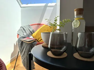 a black table with a bowl and a bottle of wine at Art Cottage with oPorto View! in Vila Nova de Gaia