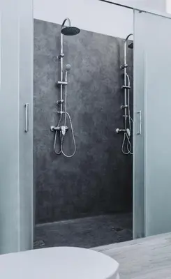 a shower in a bathroom with a mirror at OLOPO Hostel in Porto