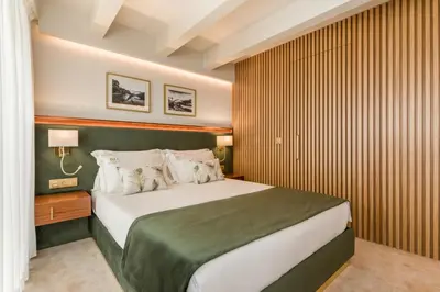 a bedroom with a large bed in a room at Ribeira Douro Hotel in Porto