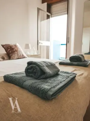 two towels sitting on top of a bed at Voga Apartments Marquês in Porto