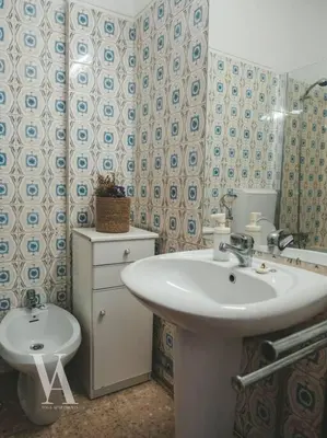 a bathroom with a sink and a toilet at Voga Apartments Marquês in Porto