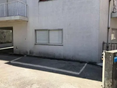a building with two windows and a parking lot at Covelo 90 in Porto