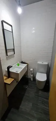 a bathroom with a toilet and a sink and a mirror at Dragon Studio in Porto