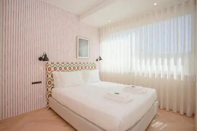 a bedroom with a white bed and a window at Allegro Boutique Apartments by Liiiving in Porto
