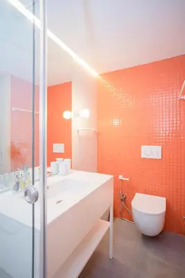 a bathroom with a white sink and a toilet at Allegro Boutique Apartments by Liiiving in Porto