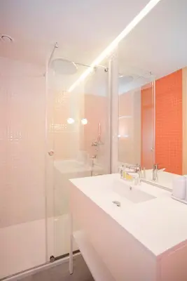 a bathroom with a white sink and a shower at Allegro Boutique Apartments by Liiiving in Porto