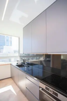 a kitchen with white cabinets and a black counter top at Allegro Boutique Apartments by Liiiving in Porto