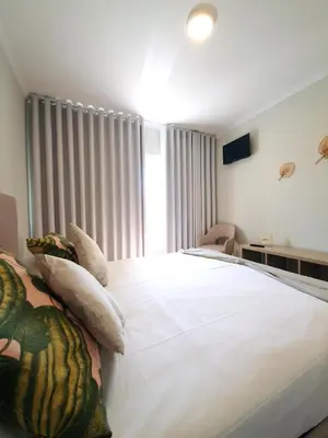 a bedroom with a large white bed and a window at Sonetos - Guest House in Porto