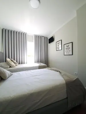 a bedroom with two beds and a window at Sonetos - Guest House in Porto