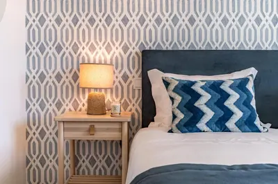 a bedroom with a bed and a table with a lamp at BONFIM LIVING - Great location, al fresco dining and free private parking in Porto