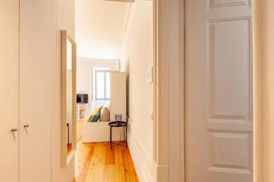 a hallway with a door leading to a bedroom at D&S - Palácio dos Príncipes in Porto