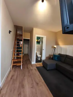 a living room with a couch and a book shelf at Gaia Style Room in a Shared Apartment in Vila Nova de Gaia