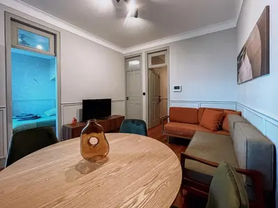 a living room with a table and a couch at Prédio da Estação in Porto