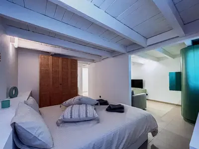 a bedroom with a white bed with two pillows at Prédio da Estação in Porto