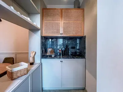 a kitchen with white cabinets and a counter at Prédio da Estação in Porto