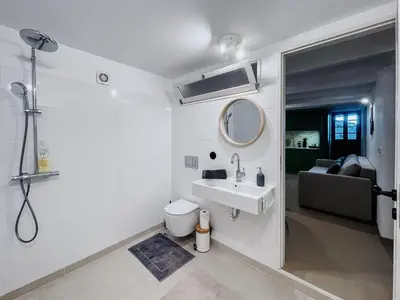 a white bathroom with a sink and a toilet at Prédio da Estação in Porto