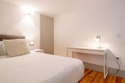 a bedroom with a bed with a blue blanket at Central Stunning Duplex w/ Patio by LovelyStay in Porto