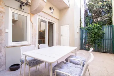 a white bathroom with a sink and a toilet at Central Stunning Duplex w/ Patio by LovelyStay in Porto