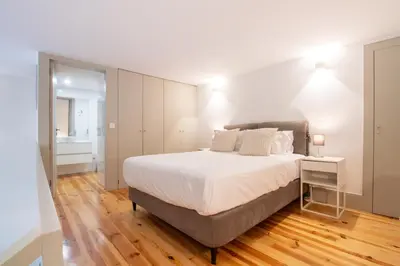 a bedroom with a bed with a blue blanket at Central Stunning Duplex w/ Patio by LovelyStay in Porto