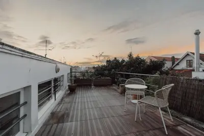 a deck with two chairs and a table on it at Papa Apartment with Terrace in Porto