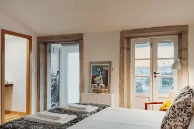 a bedroom with a bed with two towels on it at Papa Apartment with Terrace in Porto