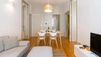 a living room with a table and a couch at Formosa Delight by LovelyStay in Porto