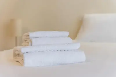 a stack of white towels sitting on a table at GuestReady - October Tide in Porto