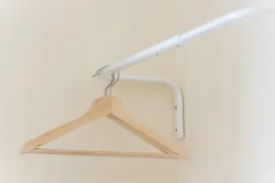 a wooden hanger hanging from a white ceiling at GuestReady - October Tide in Porto