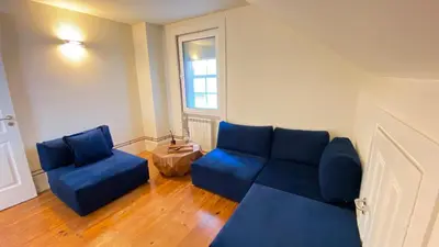 a living room with a blue couch and two chairs at Nº 91 - Almirante Guest House in Porto