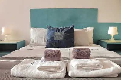 a bedroom with two towels on a bed at Oporto Early Sunshine Apartment in Porto